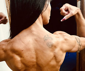 jewels jade flexes her back muscles